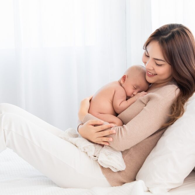 Asian,Beautiful,Mother,Motherhood,Lie,Down,Nursing,,Looking,Newborn,Baby,